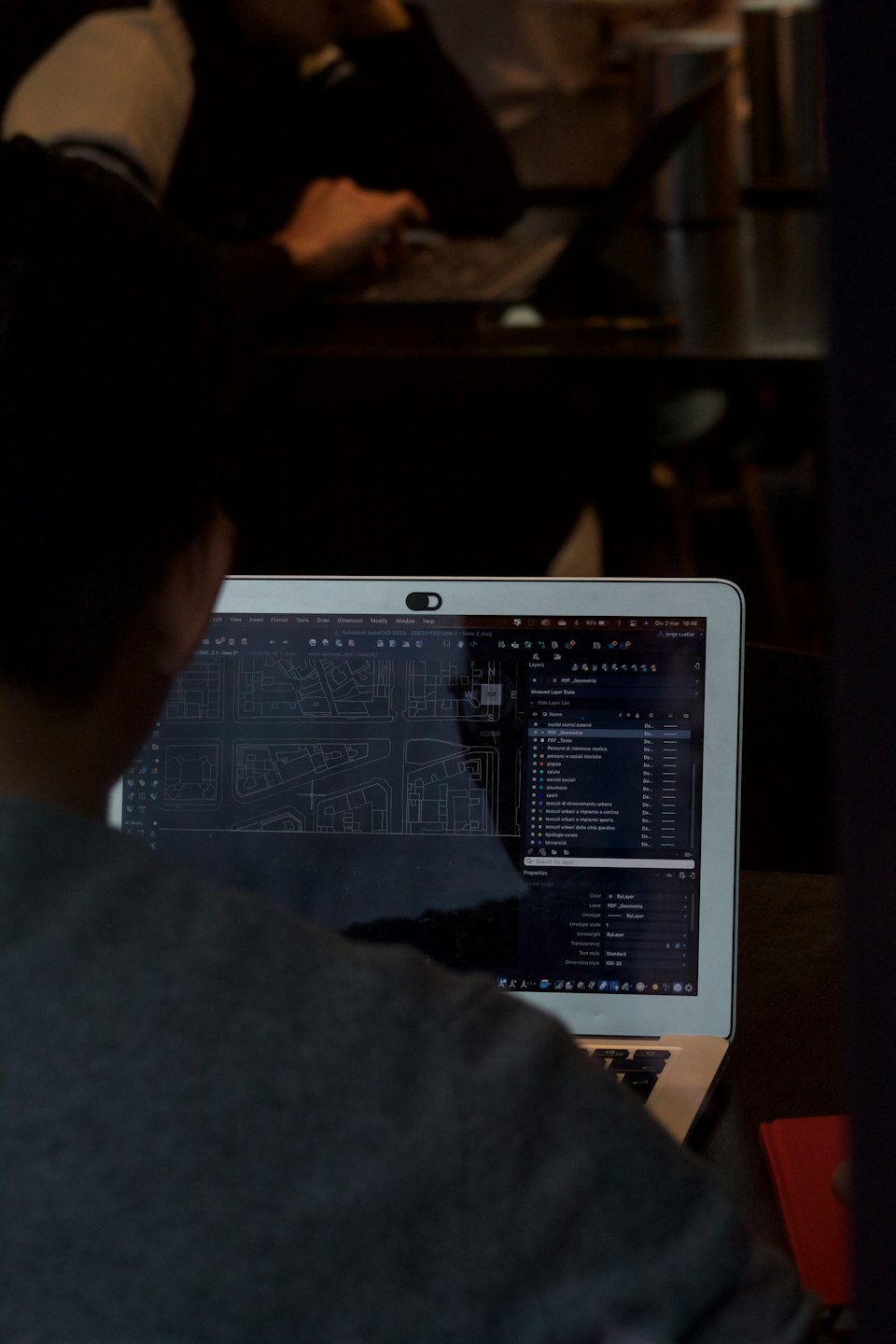 Persona che lavora su progetti architettonici al computer.